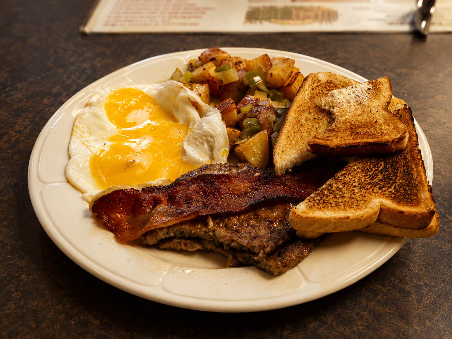 Classic diner breakfast with eggs, bacon and toast
